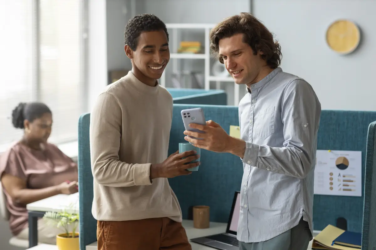 Medium shot colleagues with smartphone